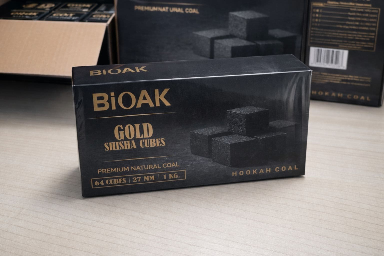 Black box of BiOAK Gold Shisha Cubes premium natural hookah coal on a wooden table.